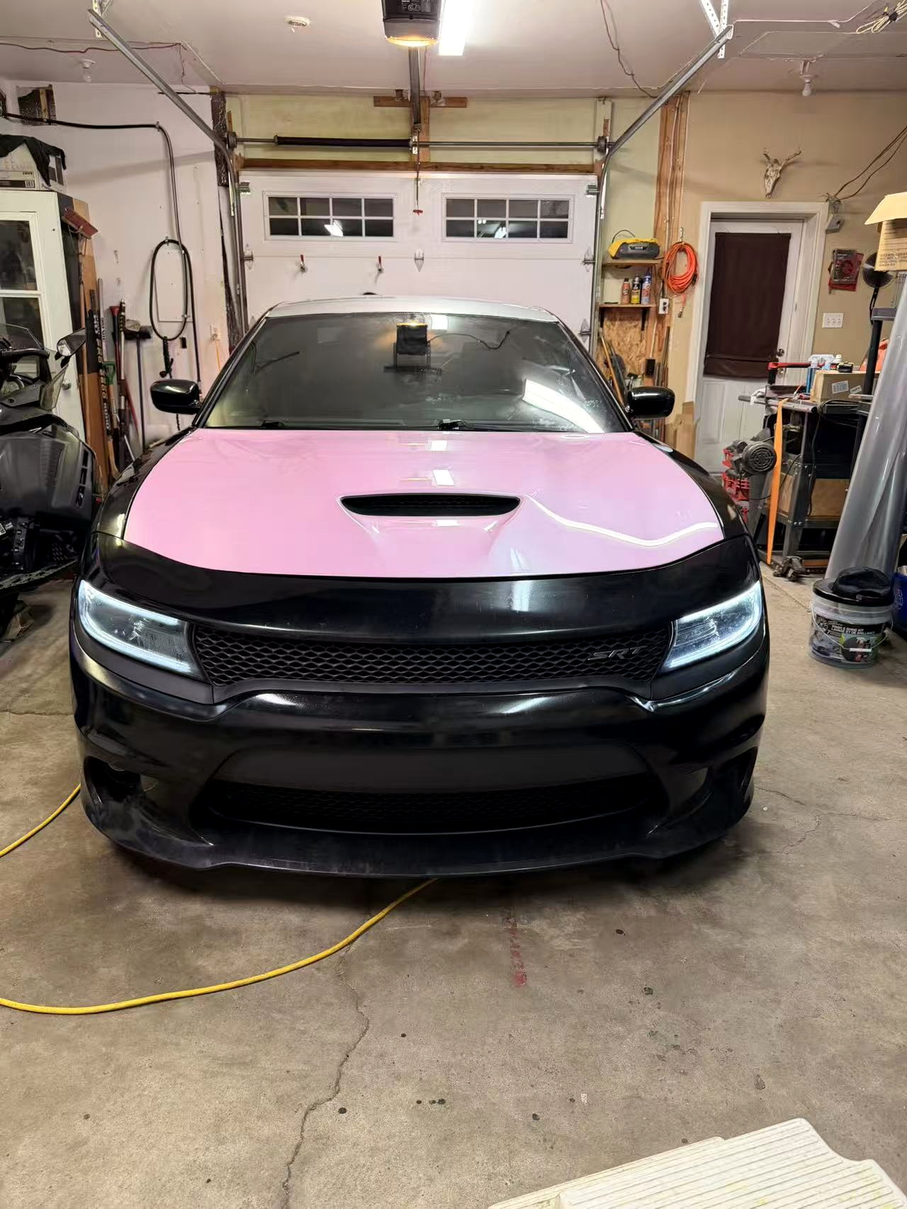 Black customer car with a pink wrapped hood