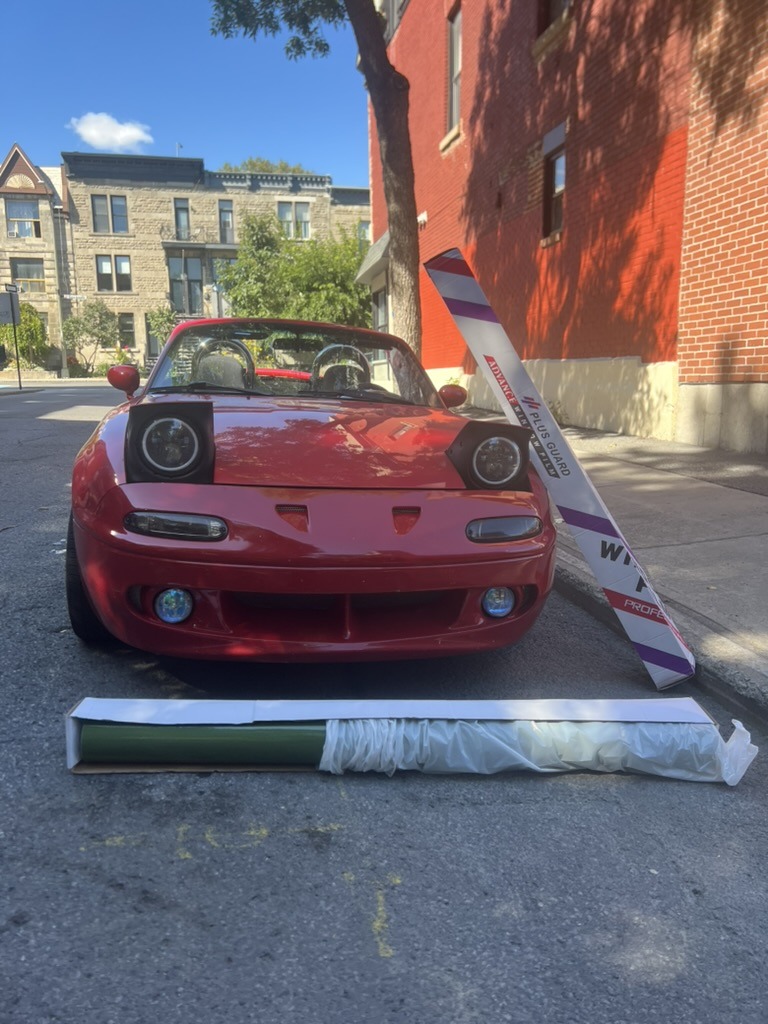 Red Mazda Miata with full vinyl wrap rolls in Montréal